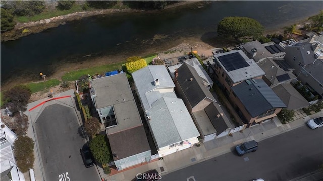 birds eye view of property with a water view and a residential view