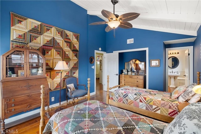 bedroom featuring visible vents, baseboards, wooden ceiling, wood finished floors, and vaulted ceiling with beams