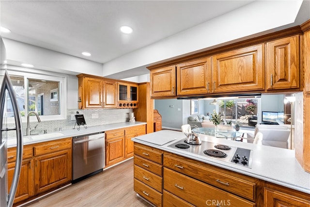 4811 Sharon Dr, La Palma, CA 90623 - kitchen featuring dishwasher, a sink, brown cabinets, light wood-style floors, and light countertops