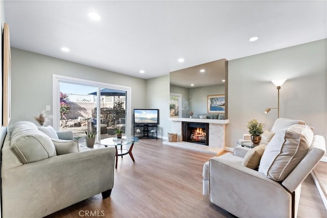 4811 Sharon Dr, La Palma, CA 90623 - living room featuring wood finished floors, recessed lighting, a lit fireplace, and baseboards
