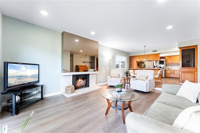 4811 Sharon Dr, La Palma, CA 90623 - living area with light wood finished floors, baseboards, a lit fireplace, and recessed lighting
