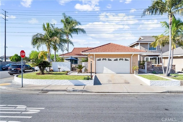 4811 Sharon Dr, La Palma, CA 90623 - view of front of house featuring a tiled roof, an attached garage, concrete driveway, and stucco siding