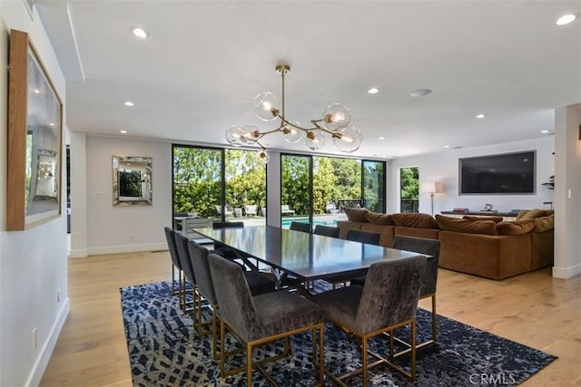 dining area featuring a chandelier, recessed lighting, light wood finished floors, and baseboards
