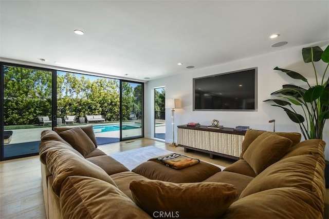 living room featuring recessed lighting, wood finished floors, and expansive windows