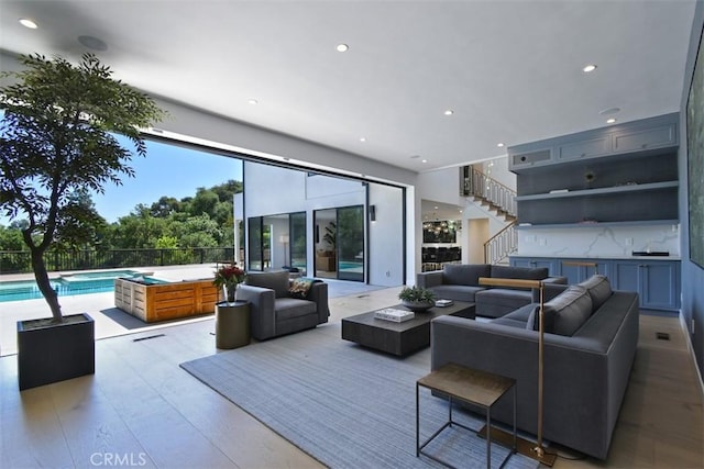 living room with recessed lighting and stairway