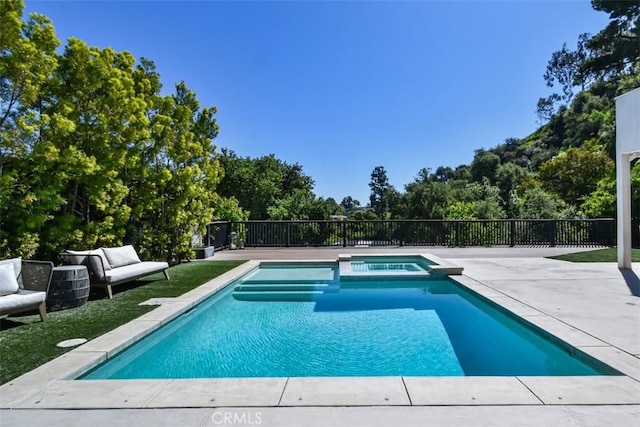 view of pool featuring a patio and a pool with connected hot tub