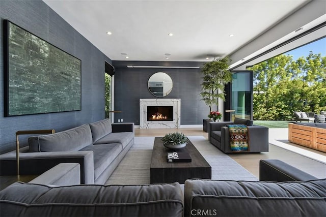 living area featuring recessed lighting, a fireplace, and plenty of natural light