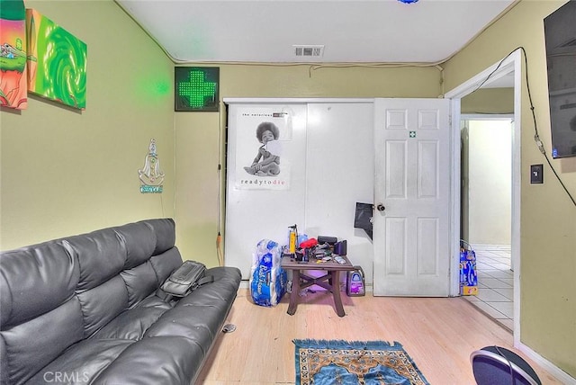 living room with wood finished floors and visible vents