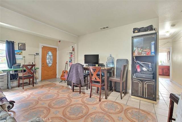 office area featuring light tile patterned floors, visible vents, and baseboards