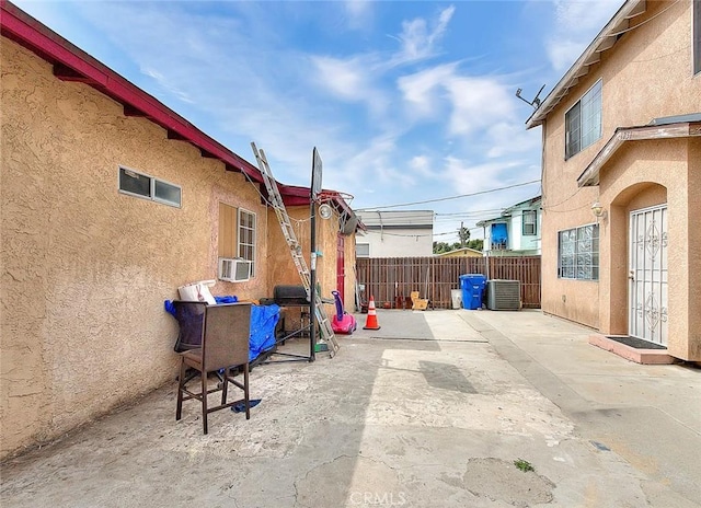 view of patio featuring fence and cooling unit