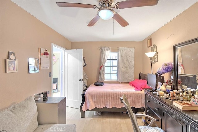 bedroom with light wood-type flooring and ceiling fan