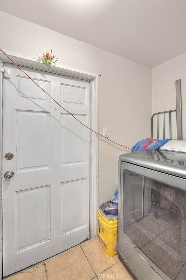 washroom with tile patterned floors and washer / dryer