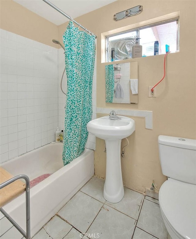 full bath with tile patterned floors, shower / tub combo with curtain, and toilet