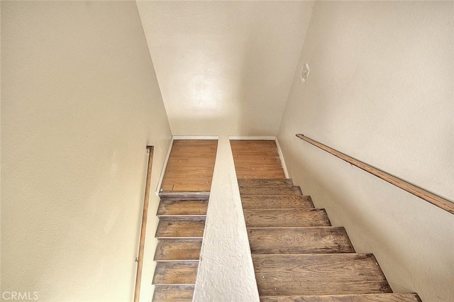 stairs featuring wood finished floors