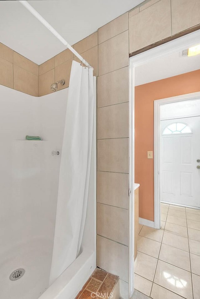 bathroom featuring tile patterned flooring and a stall shower