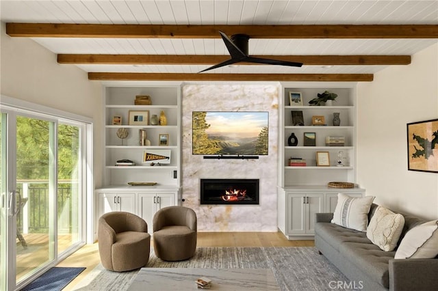 27684 St Bernard Ln, Lake Arrowhead, CA 92352 - living room featuring light wood-style floors, a high end fireplace, a wooden ceiling with exposed beams, and built in shelves