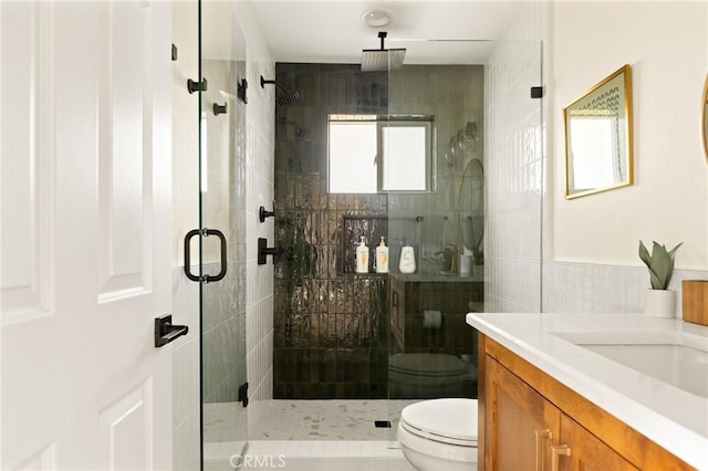 27684 St Bernard Ln, Lake Arrowhead, CA 92352 - bathroom featuring vanity, a stall shower, toilet, and tile walls