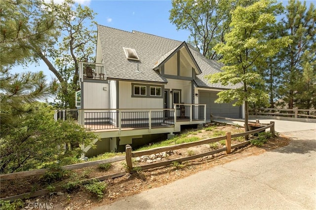27684 St Bernard Ln, Lake Arrowhead, CA 92352 - view of front facade with a shingled roof, an attached garage, concrete driveway, and a balcony