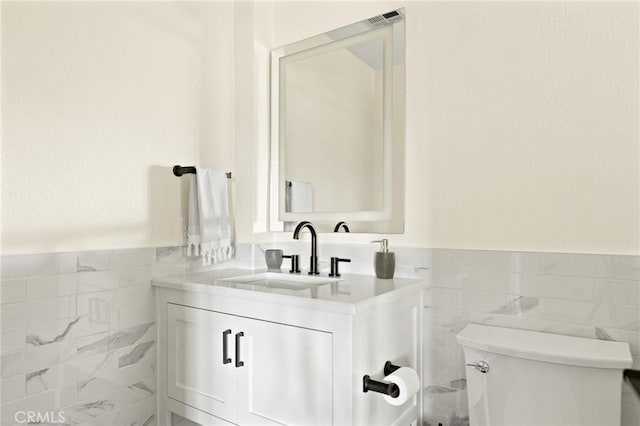 27684 St Bernard Ln, Lake Arrowhead, CA 92352 - half bath with toilet, tile walls, wainscoting, and vanity