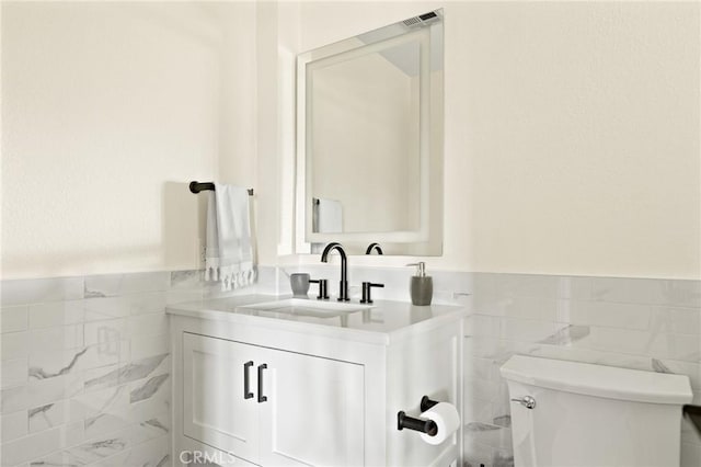 27684 St Bernard Ln, Lake Arrowhead, CA 92352 - half bath featuring tile walls, vanity, and wainscoting