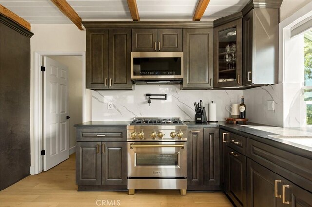 27684 St Bernard Ln, Lake Arrowhead, CA 92352 - interior space featuring light wood-style floors, decorative backsplash, beamed ceiling, and stainless steel appliances