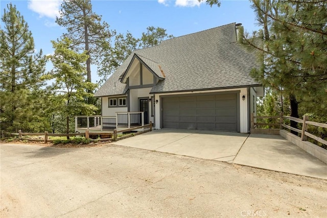 27684 St Bernard Ln, Lake Arrowhead, CA 92352 - view of front of property featuring roof with shingles, fence, a garage, a wooden deck, and concrete driveway