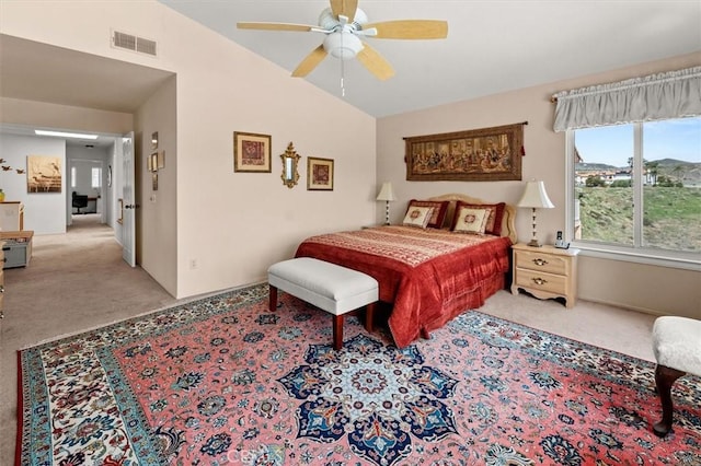 bedroom with a ceiling fan, light colored carpet, visible vents, baseboards, and lofted ceiling