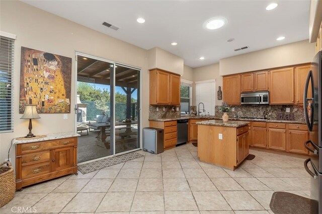 37549 Windsor Ct, Murrieta, CA 92562 - kitchen with a center island, appliances with stainless steel finishes, a sink, and visible vents