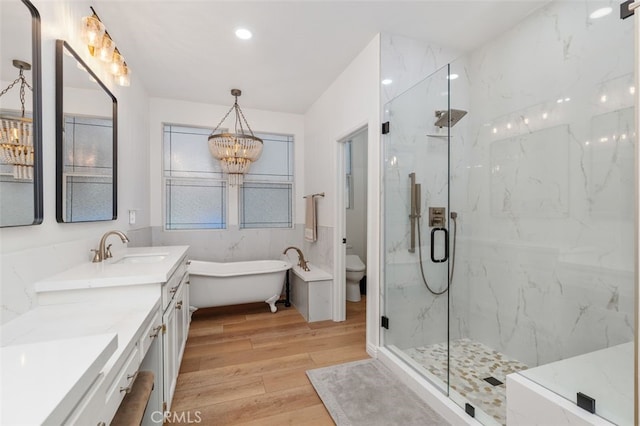 37549 Windsor Ct, Murrieta, CA 92562 - bathroom featuring vanity, a notable chandelier, toilet, a marble finish shower, and wood finished floors