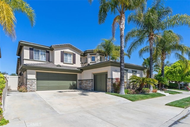 37549 Windsor Ct, Murrieta, CA 92562 - view of front of house with concrete driveway, stucco siding, stone siding, a garage, and fence