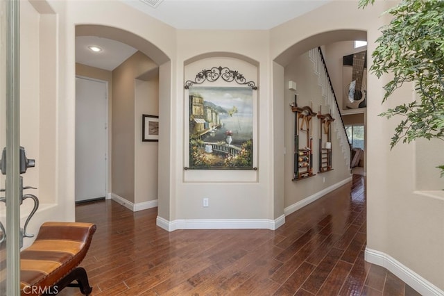 37549 Windsor Ct, Murrieta, CA 92562 - entrance foyer featuring visible vents, baseboards, arched walkways, and wood finished floors