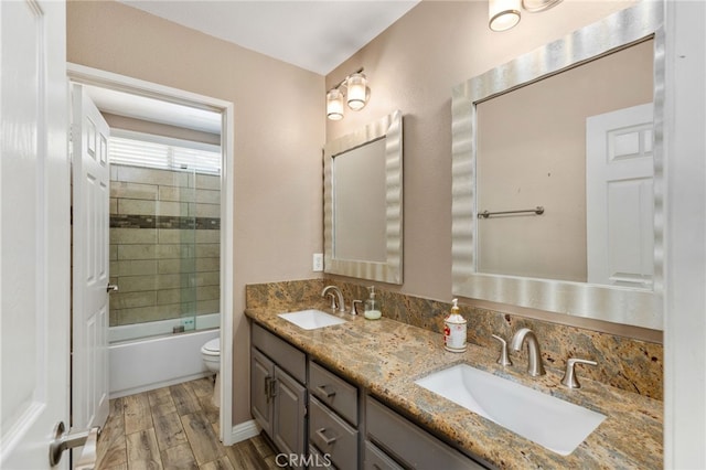 27196 Swift St, Menifee, CA 92584 - bathroom featuring double vanity, toilet, wood finished floors, and enclosed tub / shower combo