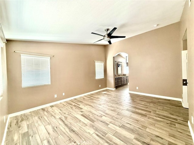 27196 Swift St, Menifee, CA 92584 - spare room with a ceiling fan, arched walkways, light wood-style floors, and baseboards