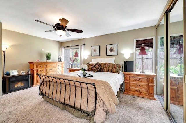 5362 Lake Murray Blvd, La Mesa, CA 91942 - bedroom featuring light carpet, a ceiling fan, and a glass covered fireplace