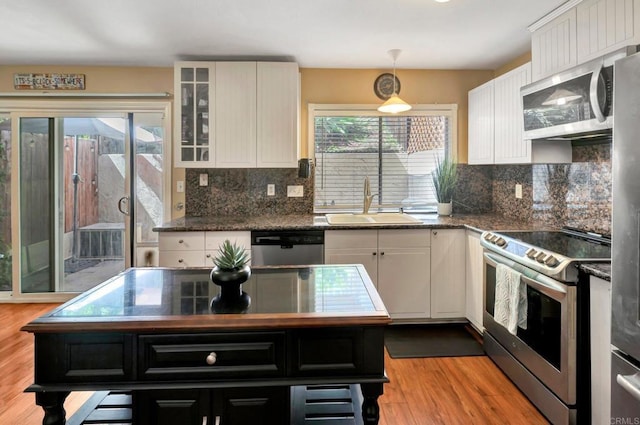5362 Lake Murray Blvd, La Mesa, CA 91942 - kitchen with white cabinets, appliances with stainless steel finishes, a sink, and light wood-type flooring