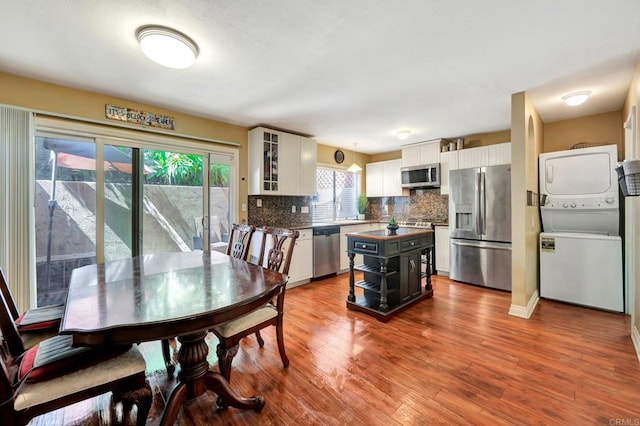 5362 Lake Murray Blvd, La Mesa, CA 91942 - dining space featuring wood finished floors and stacked washer and dryer
