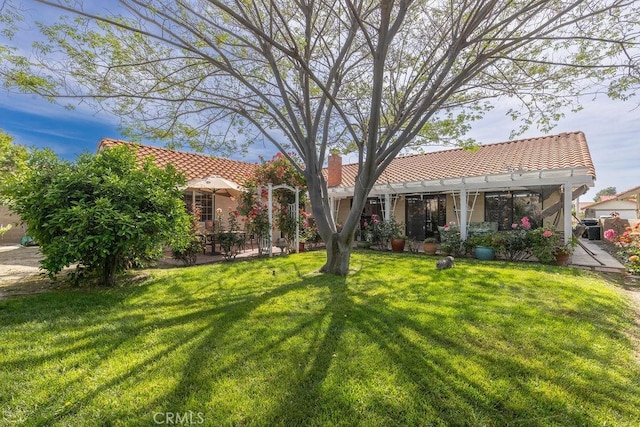 1130 Carob Ct, Hemet, CA 92545 - rear view of house featuring a tile roof, a lawn, a chimney, stucco siding, and a patio