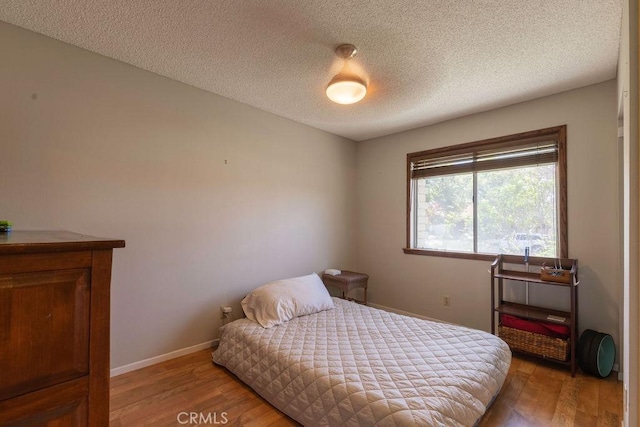 1130 Carob Ct, Hemet, CA 92545 - bedroom featuring wood finished floors and a textured ceiling
