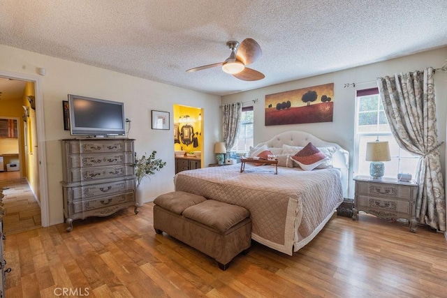1130 Carob Ct, Hemet, CA 92545 - bedroom with wood finished floors, a textured ceiling, ensuite bath, and ceiling fan