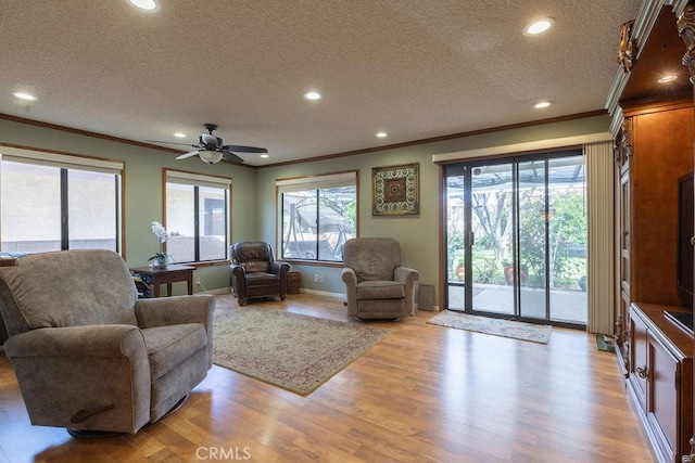 1130 Carob Ct, Hemet, CA 92545 - living area featuring ornamental molding, a textured ceiling, light wood-style flooring, recessed lighting, and ceiling fan