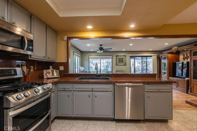 1130 Carob Ct, Hemet, CA 92545 - kitchen featuring appliances with stainless steel finishes, gray cabinets, a tray ceiling, ceiling fan, and recessed lighting