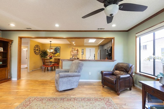 1130 Carob Ct, Hemet, CA 92545 - living area with light wood-style flooring, healthy amount of natural light, crown molding, a textured ceiling, and recessed lighting