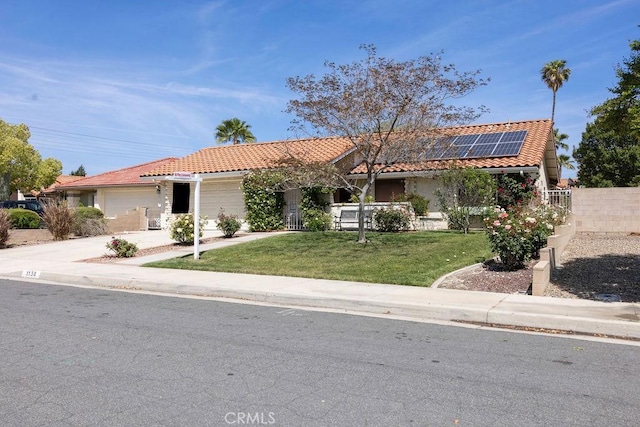 1130 Carob Ct, Hemet, CA 92545 - ranch-style home featuring an attached garage, a tile roof, solar panels, and concrete driveway