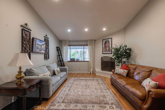 1130 Carob Ct, Hemet, CA 92545 - living area featuring light wood-style floors, recessed lighting, lofted ceiling, and a brick fireplace