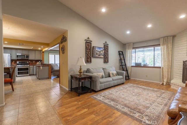 1130 Carob Ct, Hemet, CA 92545 - living area with vaulted ceiling, recessed lighting, and light tile patterned flooring
