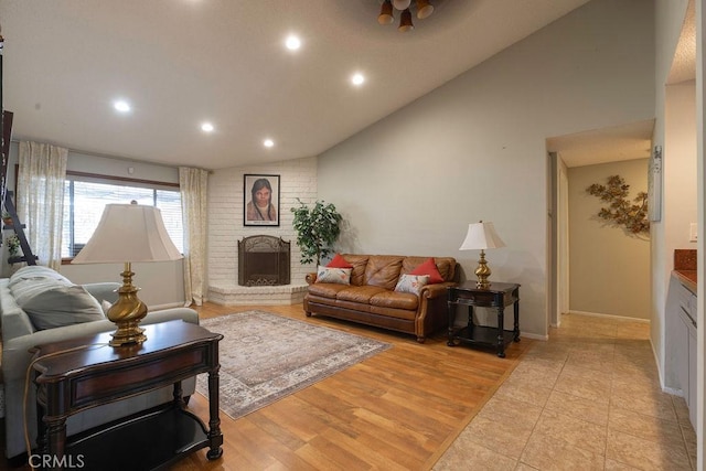 1130 Carob Ct, Hemet, CA 92545 - living room with vaulted ceiling, recessed lighting, a brick fireplace, and light wood finished floors