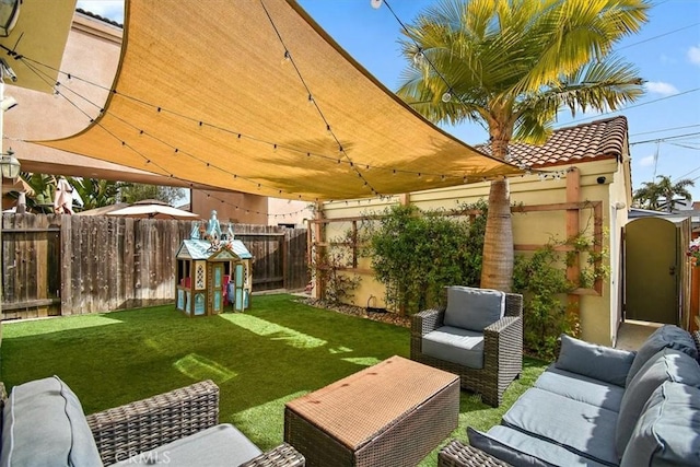 view of yard featuring fence and an outdoor hangout area
