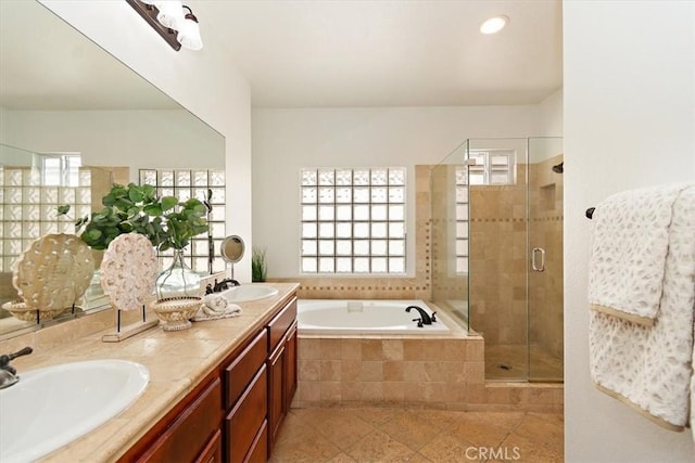 full bath featuring a garden tub, plenty of natural light, and a sink