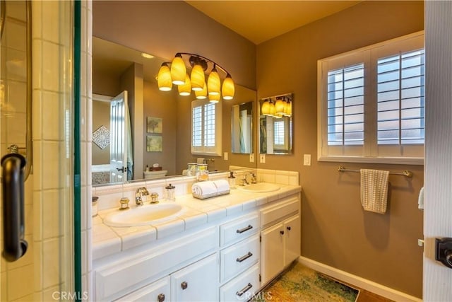 2645 S Patton Ave, San Pedro, CA 90731 - bathroom with baseboards, a sink, and double vanity