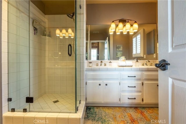 2645 S Patton Ave, San Pedro, CA 90731 - bathroom featuring double vanity, a shower stall, a sink, and a chandelier